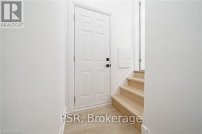 Niagara Falls (Hospital) apartment for rent - A white door with a black handle is in a room with white walls.