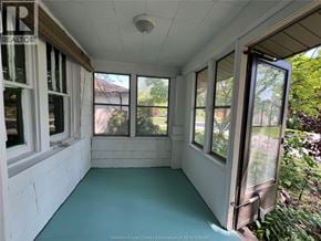 Windsor apartment for rent - A sunroom with a sliding glass door and a ceiling fan.