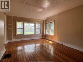 Windsor apartment for rent - A room with wooden floors and two windows.