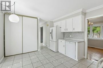 Ottawa apartment for rent - A kitchen with white cabinets and a tile floor.