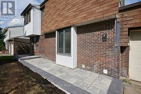 Ottawa apartment for rent - A brick house with a white door and a small window above it.