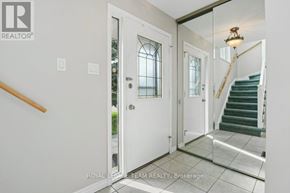 Ottawa apartment for rent - A white door with a glass window is in a hallway.