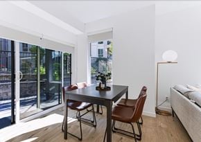 Abbotsford apartment for rent - A modern dining room with a table and chairs.