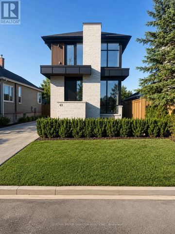 Mississauga (Port Credit) apartment for rent - A modern house with a glass window is numbered 43.