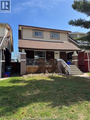 Windsor apartment for rent - A house with a brown roof and a white door is shown.