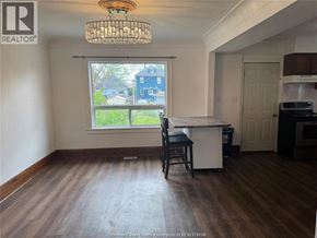 Windsor apartment for rent - A kitchen with a window overlooking a blue house.