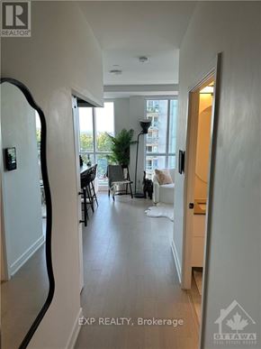 Ottawa condo for rent - A hallway with a black curved wall on the left and a white door on the right.
