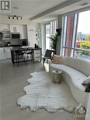 Ottawa condo for rent - A modern kitchen with a breakfast bar and a couch.