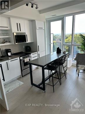 Ottawa condo for rent - A kitchen with a table and chairs in front of a window.