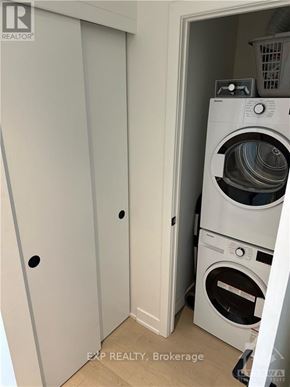 Ottawa condo for rent - A white washing machine is in a small room.