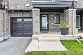Ottawa townhouse for rent - A house with a black garage door and a grey front door.