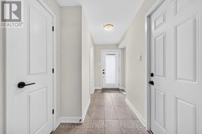 Ottawa townhouse for rent - A hallway with white doors and a tiled floor.