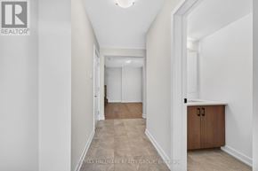 Ottawa townhouse for rent - A long hallway with a cabinet on the side and a light on the ceiling.
