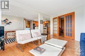 Ottawa condo for rent - A living room with a white sofa and a coffee table.