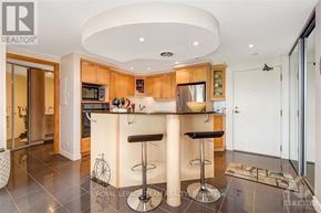 Ottawa condo for rent - A modern kitchen with a bar stool in front of the island.