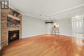 Ottawa townhouse for rent - A room with a fireplace and wood flooring.