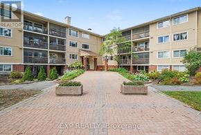 Ottawa condo for rent - A brick walkway leads to a courtyard surrounded by apartment buildings.