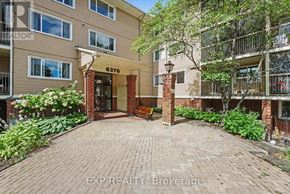 Ottawa condo for rent - The entrance to apartment building 6376 is shown with a brick walkway.