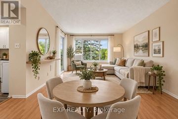 Ottawa condo for rent - A well-lit, spacious living room with a dining table and chairs, and a couch with pillows.