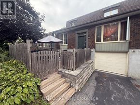 Ottawa townhouse for rent - A house with a wooden fence and a patio umbrella.