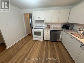 Ottawa townhouse for rent - A kitchen with white cabinets and a wooden floor.