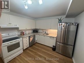 Ottawa townhouse for rent - A kitchen with white cabinets and stainless steel appliances.