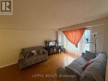 Ottawa townhouse for rent - A living room with a grey couch and a television.