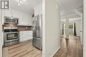 Ottawa townhouse for rent - A kitchen with white cabinets and stainless steel appliances.