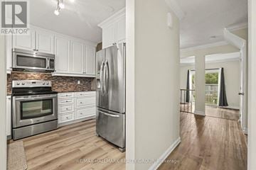 Ottawa townhouse for rent - A kitchen with white cabinets and stainless steel appliances.