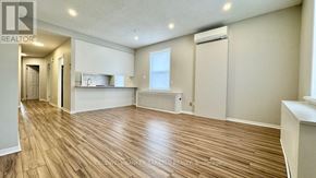Ottawa apartment for rent - A spacious room with wooden flooring and a window.