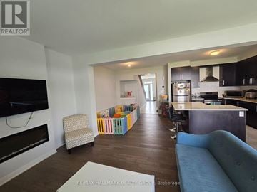 Ottawa townhouse for rent - A living room with a blue couch and a television.