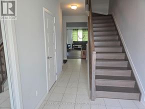 Ottawa townhouse for rent - A hallway with a staircase and a door.