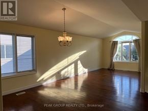 Niagara Falls (Ascot) apartment for rent - A room with a chandelier and a window with a view of a house.