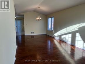 Niagara Falls (Ascot) apartment for rent - A room with wooden floors and a chandelier hanging from the ceiling.