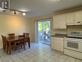 Niagara Falls (Ascot) apartment for rent - A kitchen with a table and chairs and a stove top oven.