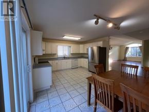 Niagara Falls (Ascot) apartment for rent - A kitchen with a table and chairs in the foreground.