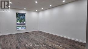 St. Catharines (Lakeport) apartment for rent - A room with a window and a wooden floor.