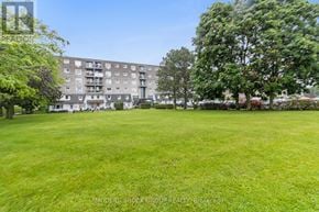 Prescott condo for rent - A grassy area in front of a building with trees.