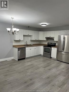 Windsor apartment for rent - A kitchen with white cabinets and a wooden island.