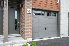 Collingwood townhouse for rent - A house with a grey garage door and a number 56 on the wall.