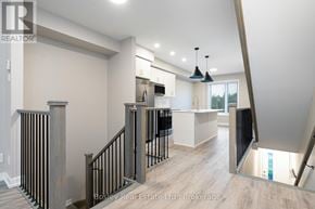 Collingwood townhouse for rent - A modern interior of a house with a staircase leading to the upper floor.