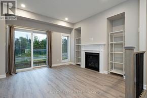 Collingwood townhouse for rent - A spacious living room with a fireplace and sliding glass doors.