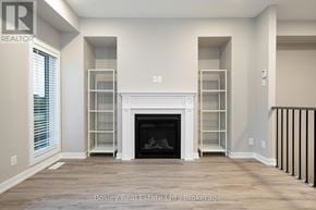 Collingwood townhouse for rent - A living room with a fireplace and built-in shelves.