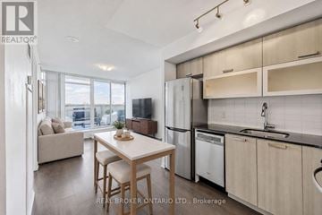 Toronto (Little Portugal) condo for rent - A modern kitchen with a dining table and chairs.