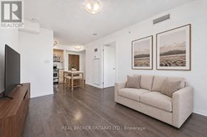 Toronto (Little Portugal) condo for rent - A living room with a couch, a television, and two pictures on the wall.