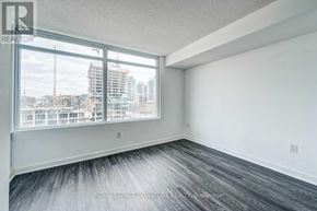 Toronto (Waterfront Communities) condo for rent - A room with a large window overlooking a construction site.