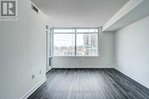 Toronto (Waterfront Communities) condo for rent - A room with a large window and a view of a city skyline.