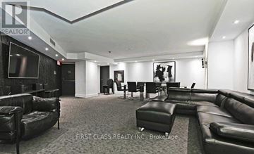 Toronto (Waterfront Communities) condo for rent - A living room with black leather furniture and a flat screen TV.
