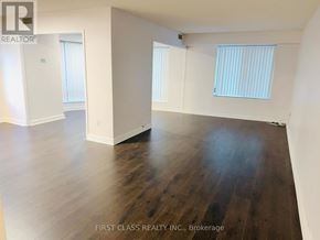 Toronto (Waterfront Communities) condo for rent - A room with wooden floors and white walls.
