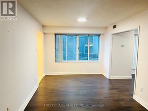 Toronto (Waterfront Communities) condo for rent - A room with a large window and wooden floors.